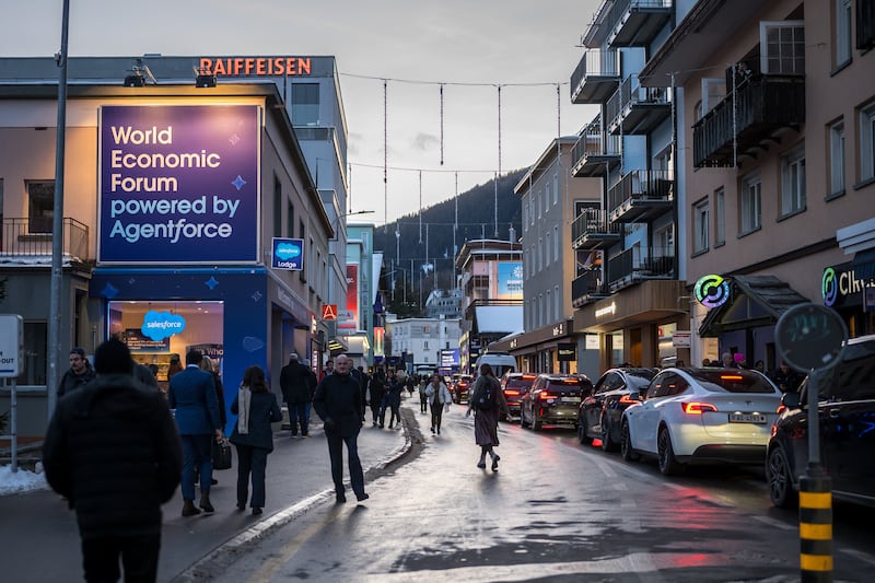 Pedestrians walk in the street during the annual meeting of the World Economic Forum (WEF) in the Alpine ressort of Davos on January 19, 2026. The World Economic Forum takes place in Davos from January 19 to January 23, 2026. (Photo by Fabrice COFFRINI / AFP via Getty Images)