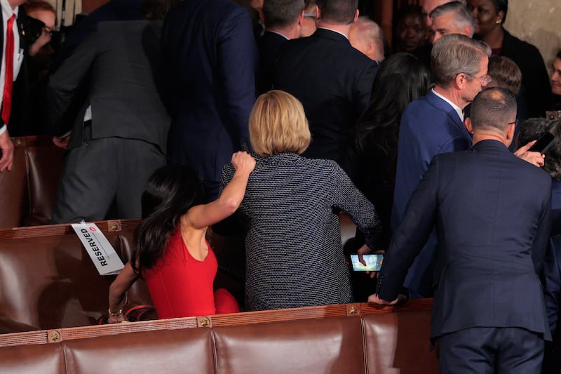 Boebert grabs onto New York Rep. Claudia Tenney as she falls off of the seat she was standing in to watch Trump leave the Capitol after his State of the Union address.