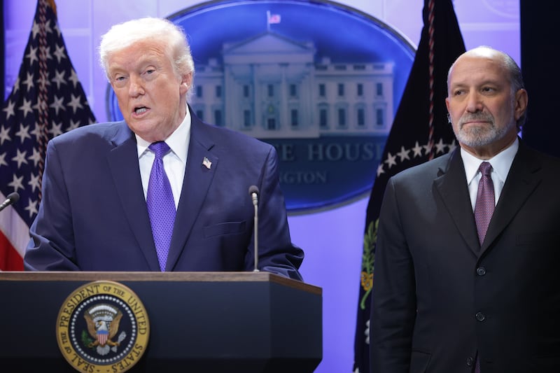 President Donald Trump speaks during a press briefing on February 20, 2026, with Commerce Secretary Howard Lutnick at his side.