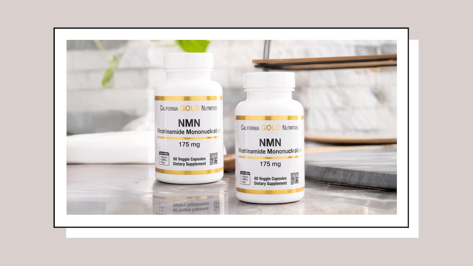 Two bottles of California Gold Nutrition NMN supplement on a countertop