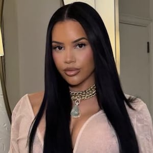 Lateysha Grace in a beige dress