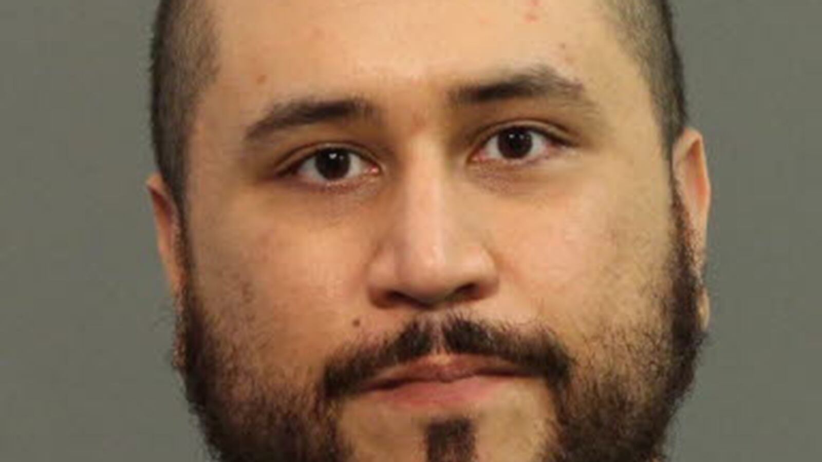 articles/2013/11/18/how-george-zimmerman-ended-up-behinds-bars-again/131118-zimmerman-mug-cheat_rpioes