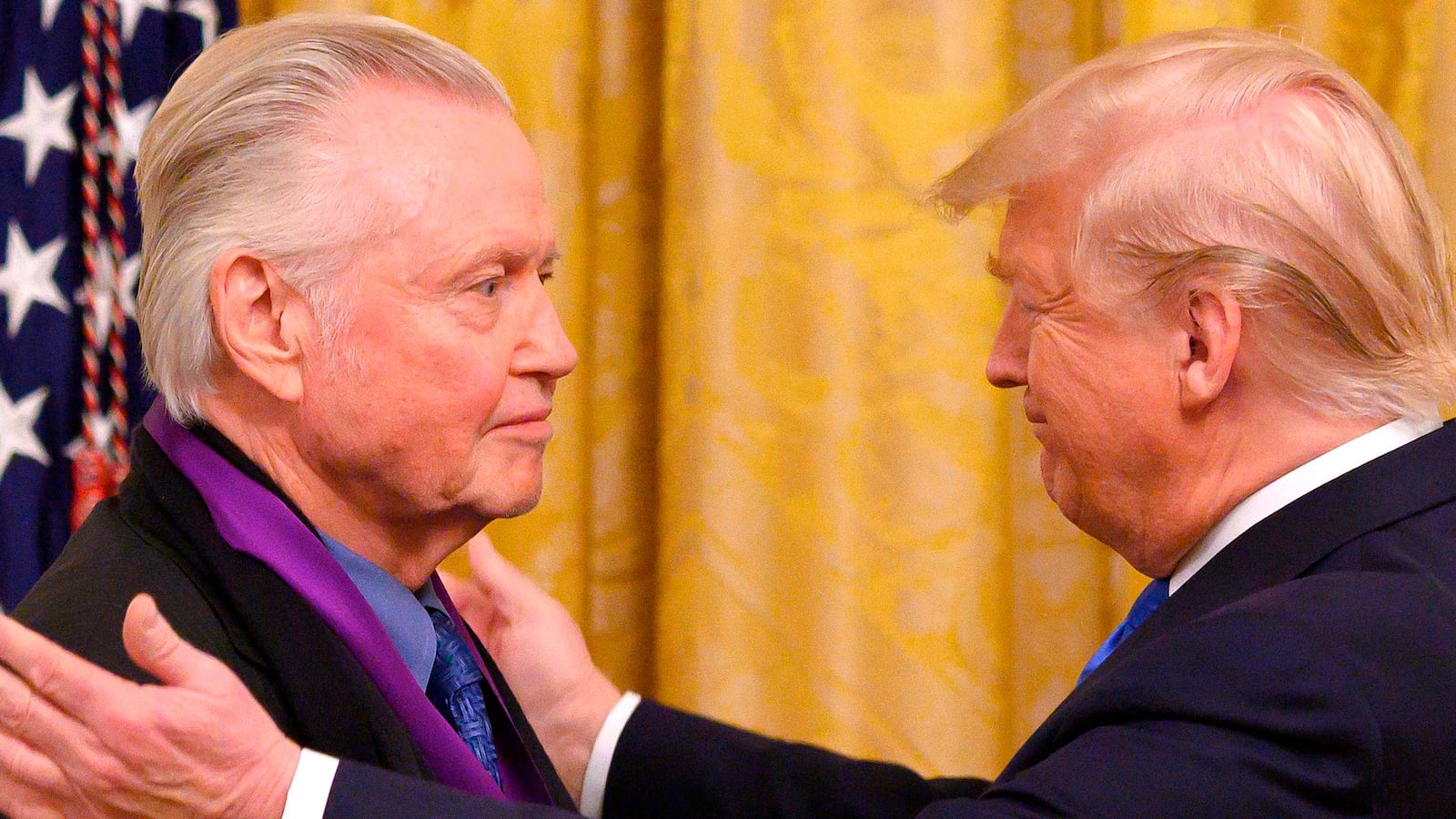 US President Donald Trump awards the National Medal of Arts to actor Jon Voight (L) in 2019.