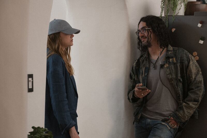 Emma Stone stands in a doorway across from Benny Safdie in a still from ‘The Curse’