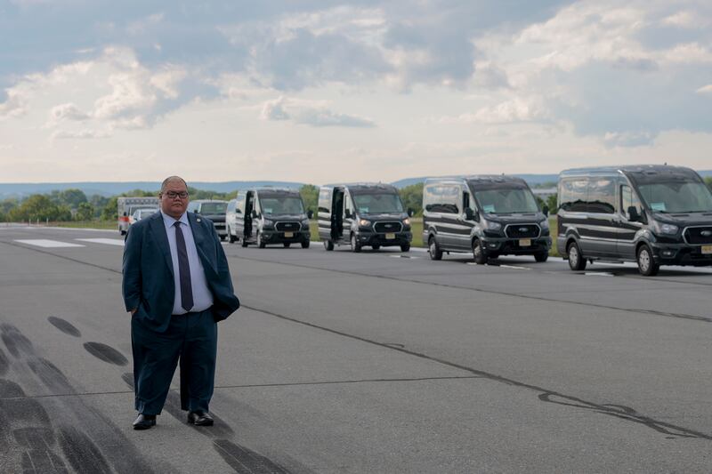 White House Communications Director Steven Cheung looks on as U.S. President Donald Trump walks off Air Force One.