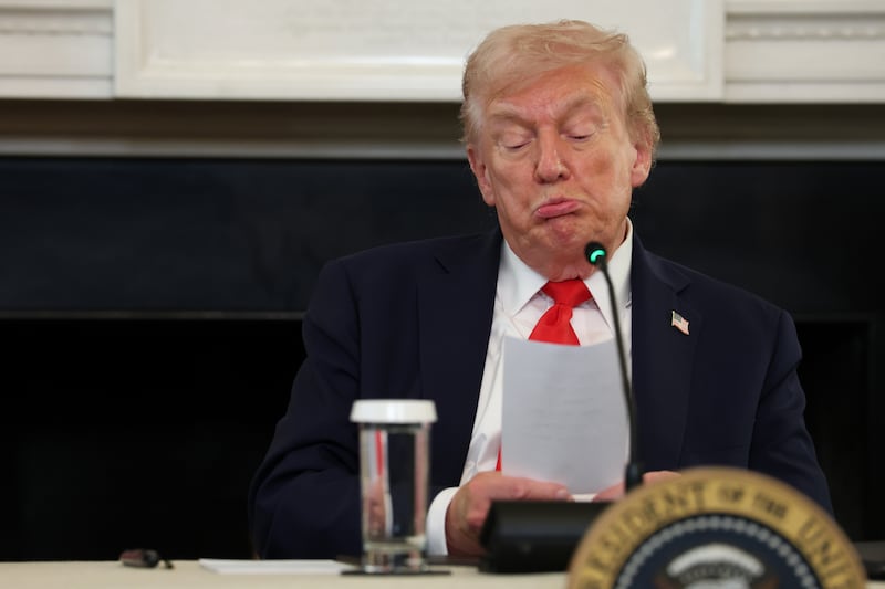 WASHINGTON, DC - OCTOBER 08: U.S. President Donald Trump reads a note handed to him by U.S. Secretary of State Marco Rubio he said was regarding Middle East peace talks during a roundtable discussion in the State Dining Room of the White House on October 08, 2025 in Washington, DC. Trump’s administration held the roundtable to discuss the anti-fascist Antifa movement after signing an executive order designating it as a “domestic terrorist organization”. (Photo by Anna Moneymaker/Getty Images)