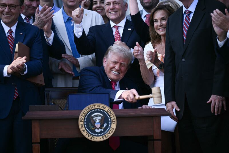 President Donald Trump bangs a gavel after signing the "Big Beautiful Bill Act" at the White House on July 4, 2025.