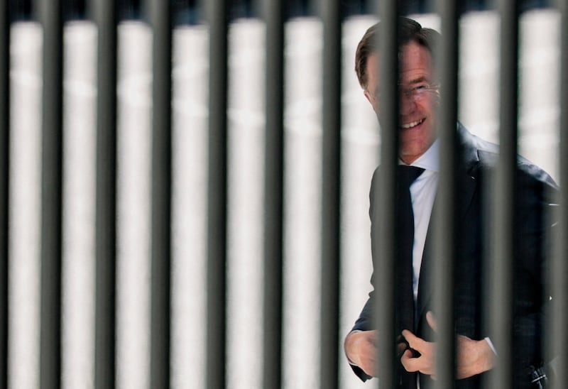 NATO Secretary General Mark Rutte walks into the White House, as seen through a fence, in Washington, D.C., U.S., April 8, 2026. REUTERS/Evan Vucci