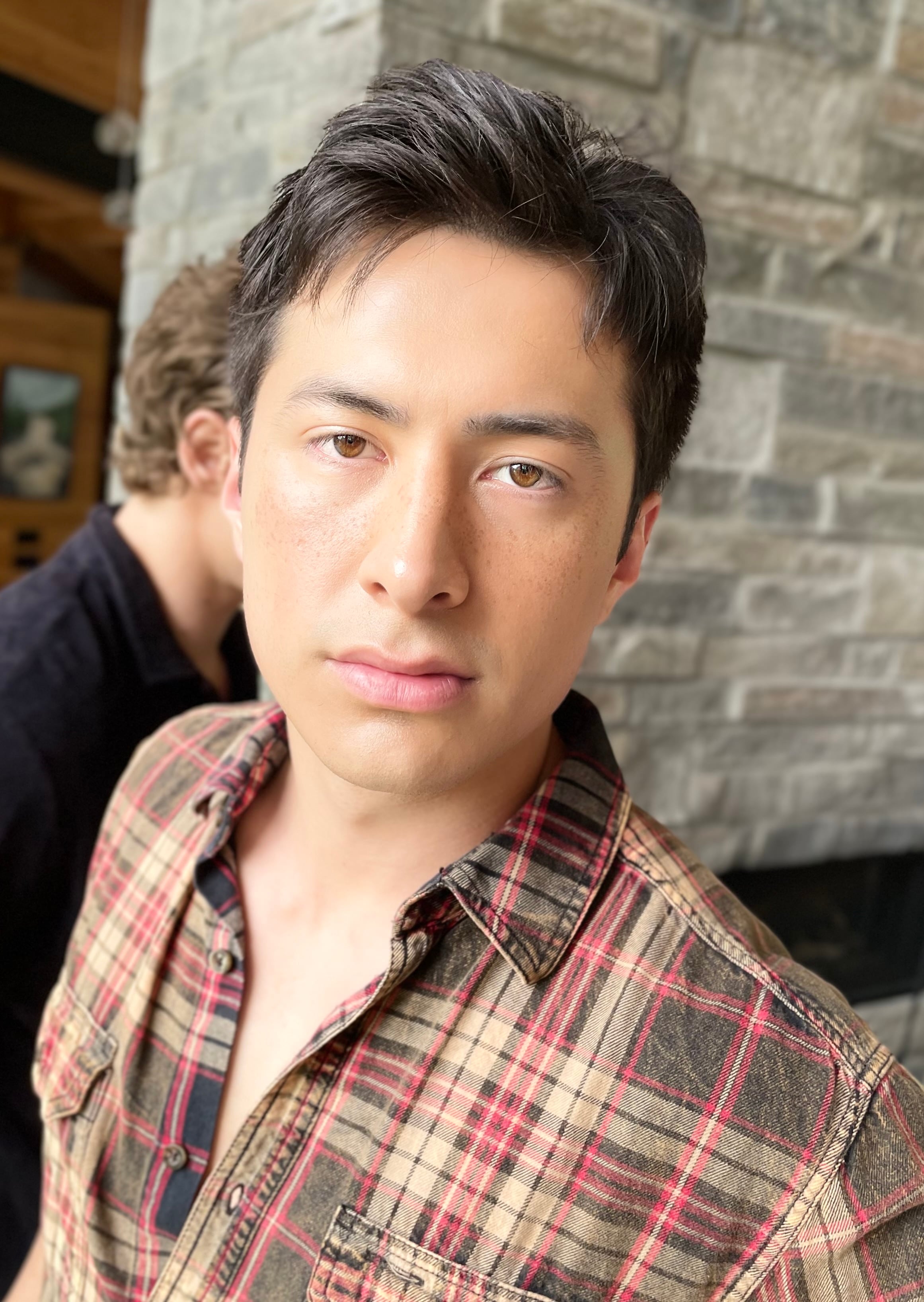 A behind-the-scenes photo of Hudson Williams's makeup on set.