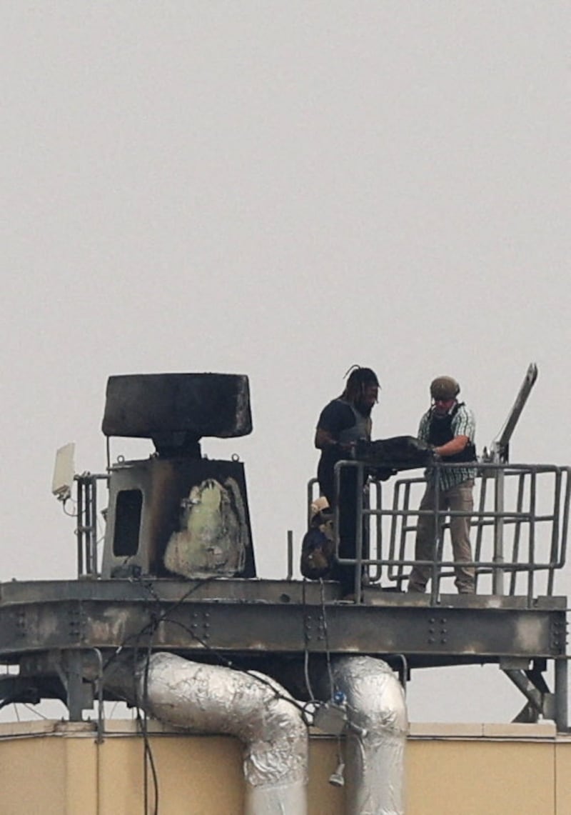 U.S. soldiers inspect a site at the U.S. embassy, after Iraqi security sources said it was hit in a missile attack, in Baghdad, Iraq, March 14, 2026. REUTERS/Ahmed Saad