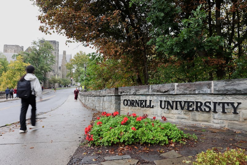 FILE PHOTO: A student walks by a sign at the entrance of Cornell University in Ithaca, New York, US, October 1, 2026. REUTERS/Lauren Petracca/File Photo