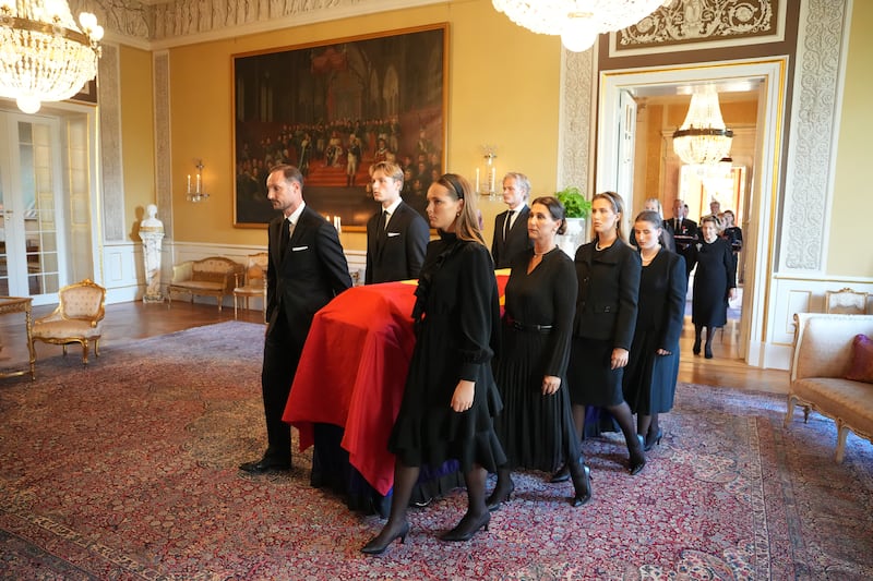 The coffin of King Harald V of Norway is moved from the Red Salon to the Palace Chapel in Oslo on August 31 by members of the royal family.