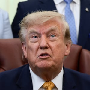 U.S. President Donald Trump answers questions from the media after signing an executive order establishing the President's Military Spouse Commission to be chaired by Jennifer Rauchet, wife of Secretary of Defense Pete Hegseth, in the Oval Office at the White House in Washington, D.C., U.S., August 3, 2026.