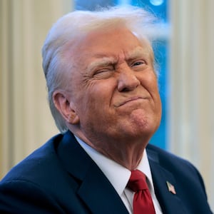 President Donald Trump reacts to a reporter's question from the Resolute Desk after signing an executive order to appoint the deputy administrator of the Federal Aviation Administration in the Oval Office at the White House on January 30, 2025 in Washington, DC.