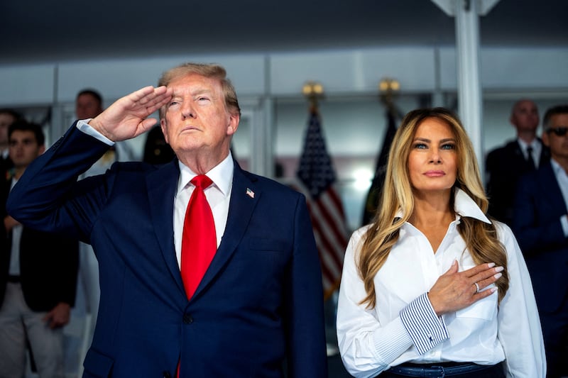 U.S. President Donald Trump with first lady Melania Trump during the National Anthem at the start of the Freedom 250 Grand Prix race on the streets of Washington, D.C.,  U.S., August 23, 2026. Doug Mills/Pool via REUTERS