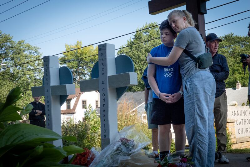 A gunman fired through the windows of the church while students were sitting in pews during a Catholic school Mass, killing two children and injuring at least 17 others. The gunman reportedly died at the scene from a self-inflicted gunshot wound, according to police. (Photo by Scott Olson/Getty Images)