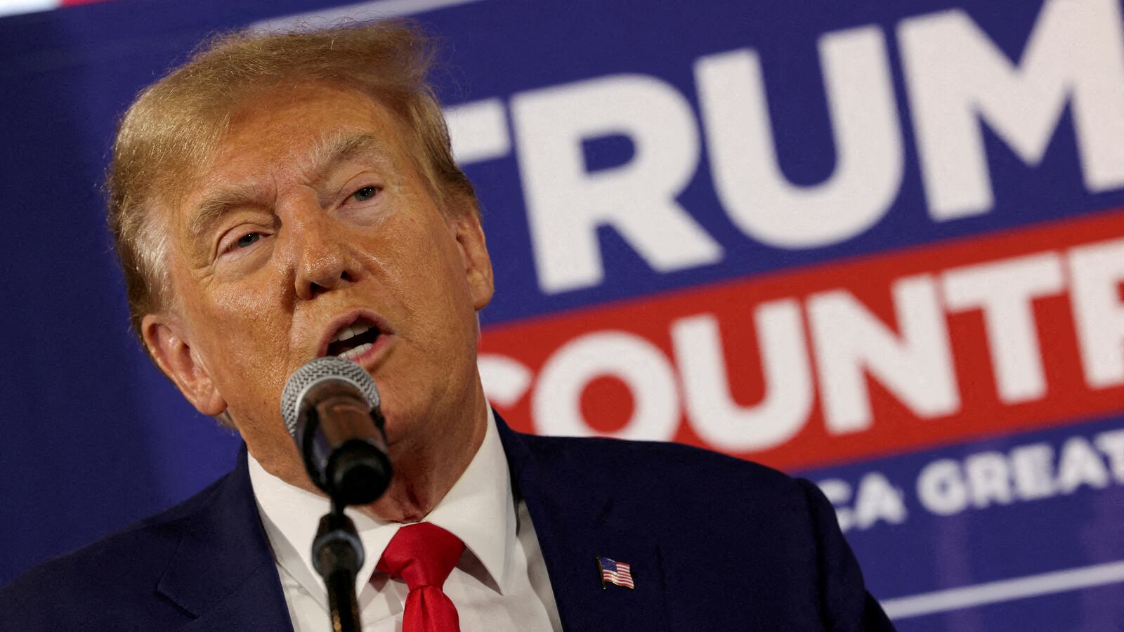Donald Trump rallies with supporters at a “commit to caucus” event at a Whiskey bar in Ankeny, Iowa.