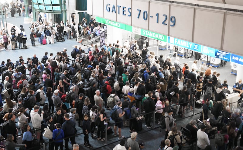 Travelers wait in a TSA screening line at Orlando International Airport on March 22, 2026 in Orlando, Florida.
