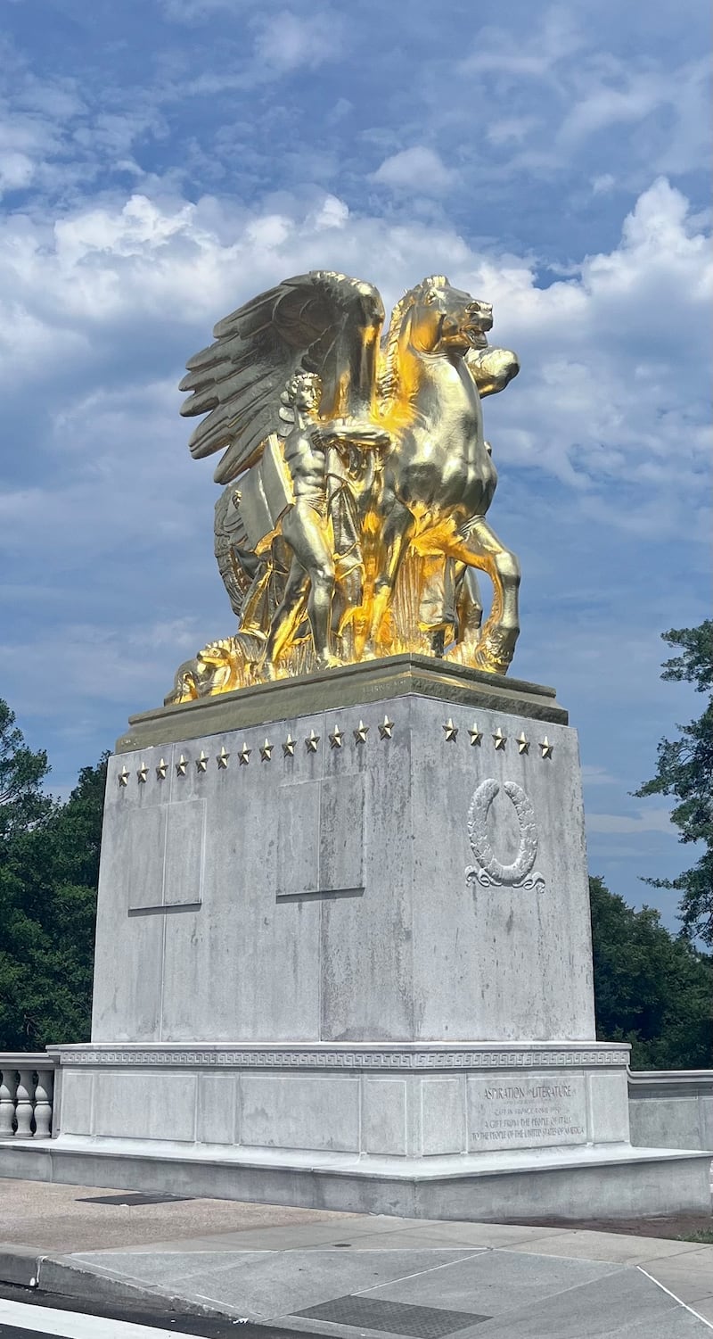 Trump's new 24-karat gold statue behind the Lincoln Memorial.