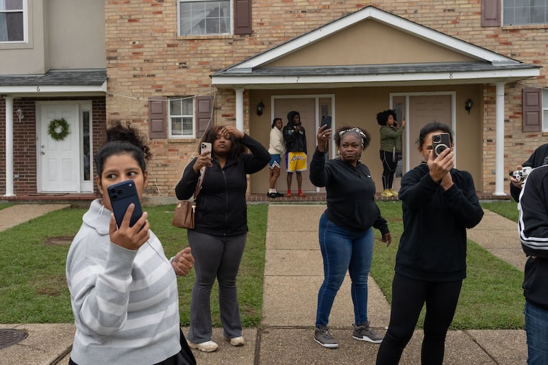 Residents watch and film as US Customs and Border Patrol Commander Gregory Bovino and fellow agents conduct operations.