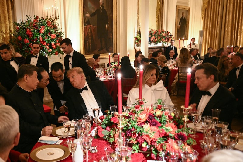 China's President Xi Jinping (L) and President Donald Trump speak through interpreters as First Lady Melania Trump listens to Tesla CEO Elon Musk during a State Dinner in the East Room of the White House in Washington, DC, on September 24, 2026.