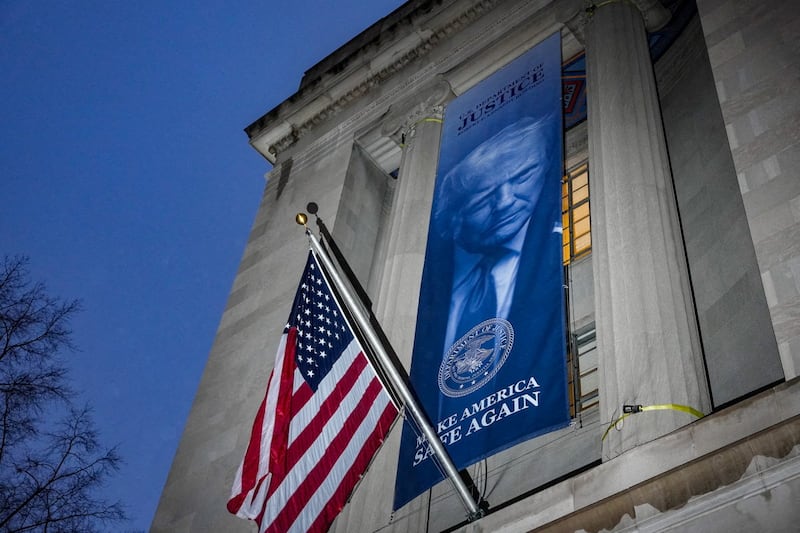 A banner depicting U.S. President Donald Trump is put up on the Department of Justice building in Washington, D.C., U.S., February 20, 2026.