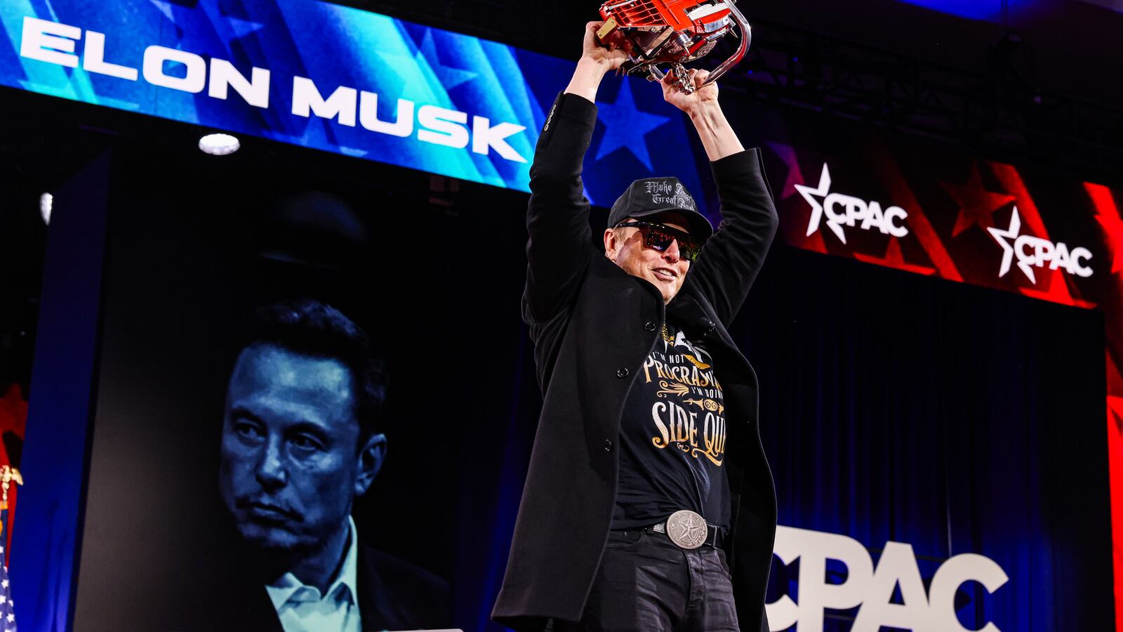 Elon Musk waves around a chainsaw on stage at the Conservative Political Action Conference in February.