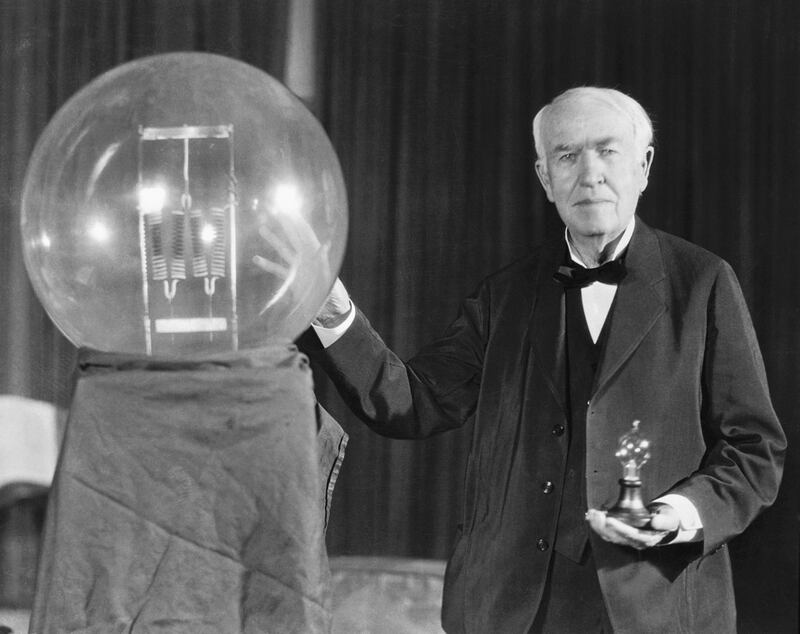 (Original Caption) Thomas A. Edison exhibits a replica of his first successful incandescent lamp, which gave 16 candlepower of illumination, in contrast to the ultimate in today's achievement, a 50,000 watt, 150,000 candlepower lamp.