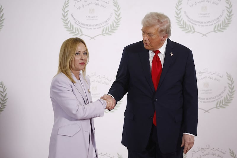 U.S. President Donald Trump and Italian Prime Minister Giorgia Meloni shake hands as they pose for a photo, at a world leaders' summit on ending the Gaza war, amid a U.S.-brokered prisoner-hostage swap and ceasefire deal between Israel and Hamas, in Sharm el-Sheikh, Egypt, October 13, 2025.