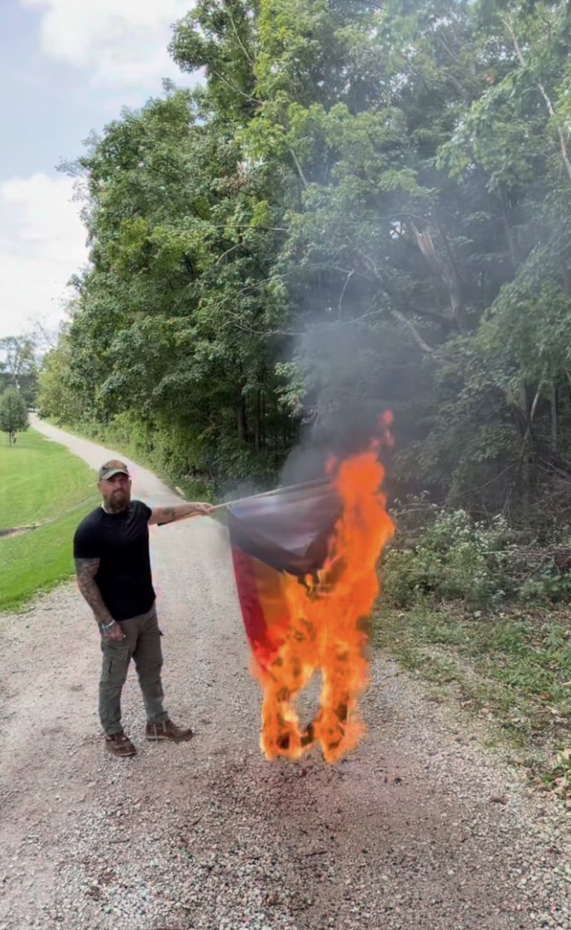 Country rapper Adam Calhoun burning a pride flag.