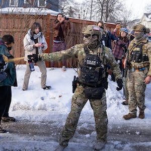 MINNEAPOLIS, MN. - JANUARY 2026: A Border Patrol Tactical Unit agent sprays pepper spray into the face of a protestor attempting to block an immigration officer vehicle from leaving the scene where a woman was shot and killed by a federal agent earlier, in Minneapolis, Minn. on Wednesday, January 7, 2026. The Department of Homeland Security confirmed that a woman was shot and killed by an Immigration and Customs Enforcement (ICE) agent during a confrontation between federal agents and protesters in south Minneapolis. (Photo by Alex Kormann/The Minnesota Star Tribune via Getty Images)