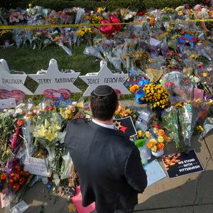 A man prays at a makeshift memorial outside the Tree of Life synagogue.