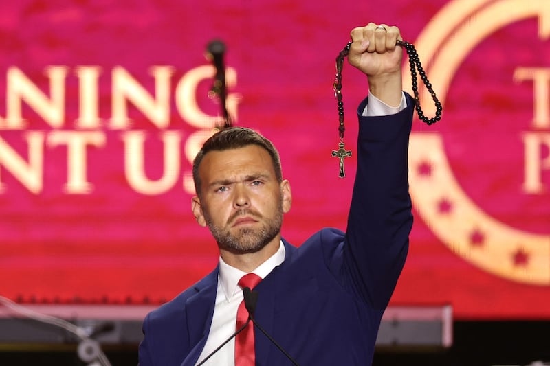 US political activist Jack Posobiec holds up a rosary as he speaks during the public memorial service for right-wing activist Charlie Kirk at State Farm Stadium in Glendale, Arizona, on September 21, 2025. (Photo by Patrick T. Fallon / AFP) (Photo by PATRICK T. FALLON/AFP via Getty Images)
