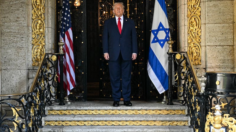 US President Donald Trump waits for the arrival of Israeli Prime Minister Benjamin Netanyahu at Trump's Mar-a-Lago residence in Palm Beach, Florida, on December 29, 2025. (Photo by Jim WATSON / AFP via Getty Images)