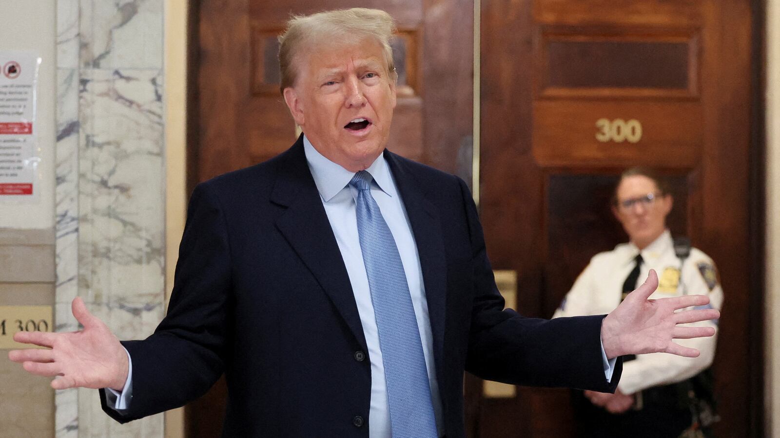 Former U.S. President Donald Trump speaks in the hall way as he attends his Manhattan courthouse trial in a civil fraud case in New York, U.S.