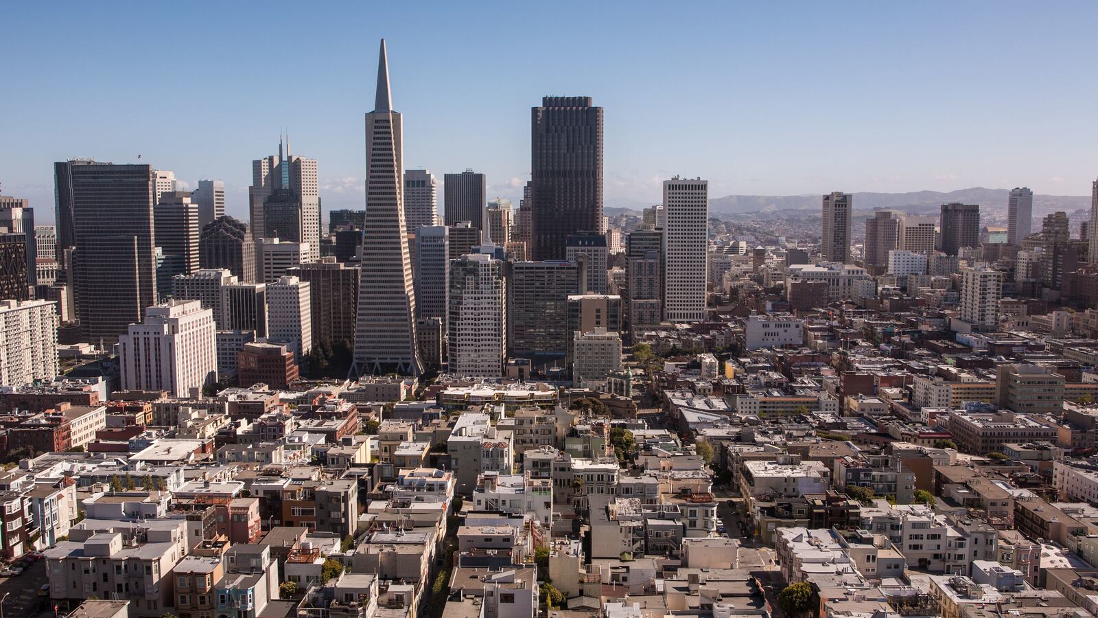 The downtown San Francisco skyline is viewed from Telegraph Hill and Coit Tower.