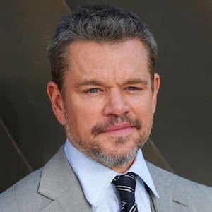 Matt Damon smiles on the red carpet at the world premiere of “The Odyssey" in 2026.