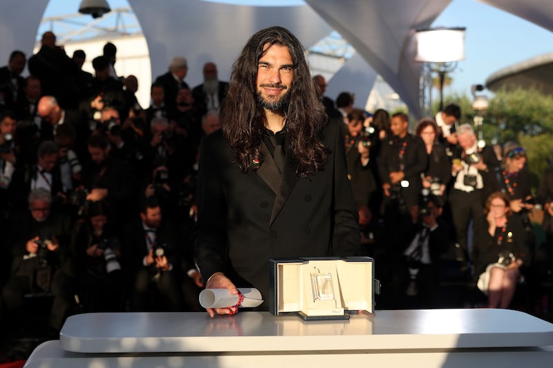 Óliver Laxe poses with the Jury Prize (TIE) for “Sirat” during the Palme D'Or winners photocall at the 78th annual Cannes Film Festival at Palais des Festivals on May 24, 2025 in Cannes, France.