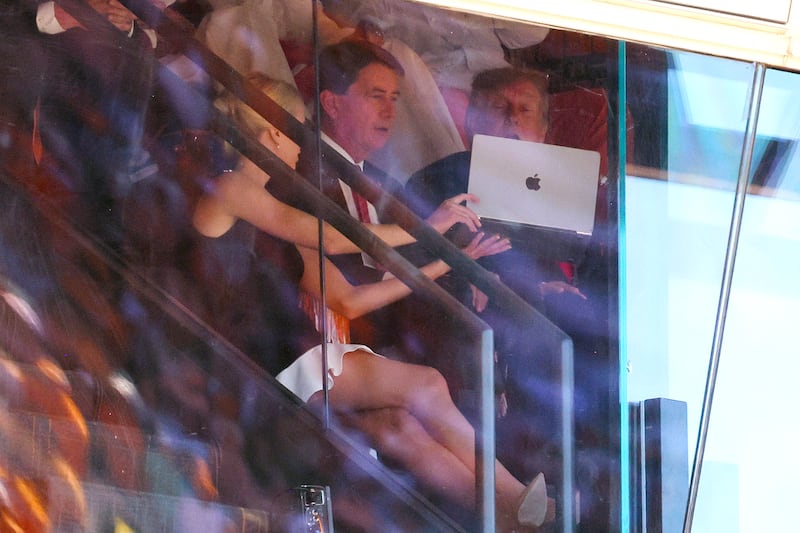 KNOXVILLE, TENNESSEE - SEPTEMBER 26: U.S. President Donald Trump and Sen. Bill Hagerty (R-TN) are shown a laptop computer by Trump's personal assistant Natalie Harp during the Texas-Tennessee football game at Neyland Stadium on September 26, 2026 in Knoxville, Tennessee. Trump, who has attended more college football games than any recent sitting president, attended the game between the No. 1 Longhorns and the No. 14. Volunteers, one of the biggest matchups in the country this weekend. (Photo by Tom Brenner/Getty Images)