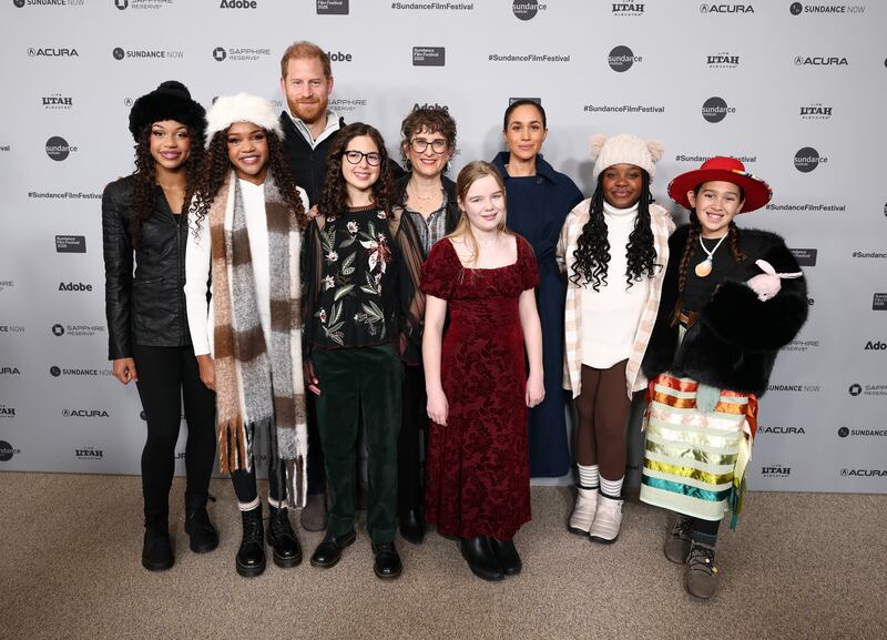 Prince Harry and Meghan, Duchess of Sussex, posed at the Sundance premiere of "Cookie Queens" with members of the documentary's cast.