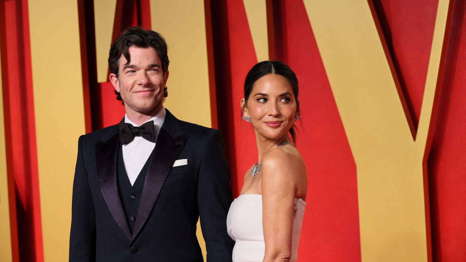 John Mulaney and Olivia Munn smiling at an Oscars after party