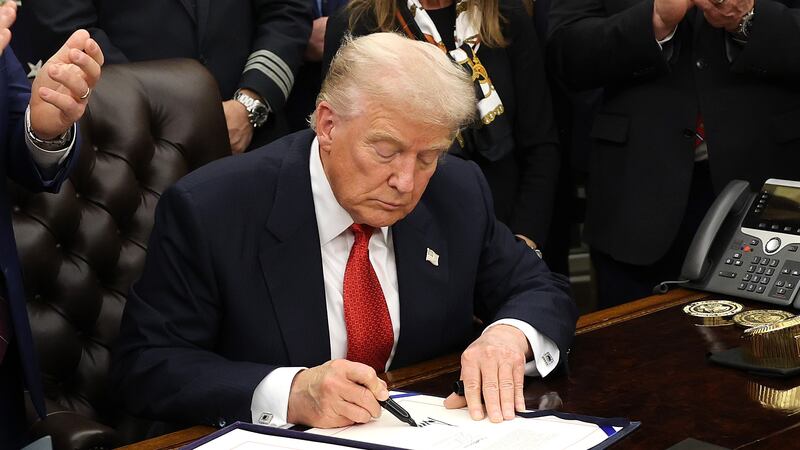 WASHINGTON, DC - NOVEMBER 12: U.S. President Donald Trump signs funding legislation to reopen the federal government as he is joined by House Minority Leader Steve Scalise (R-LA), House Speaker Mike Johnson (R-LA), Republican lawmakers and business leaders, during a ceremony in the Oval Office of the White House on November 12, 2025, in Washington, DC. The legislation, passed by the House of Representatives tonight, funds the federal government until the end of January 2026 and ends the 43-day government shutdown, the longest in the nation’s history. (Photo by Win McNamee/Getty Images)