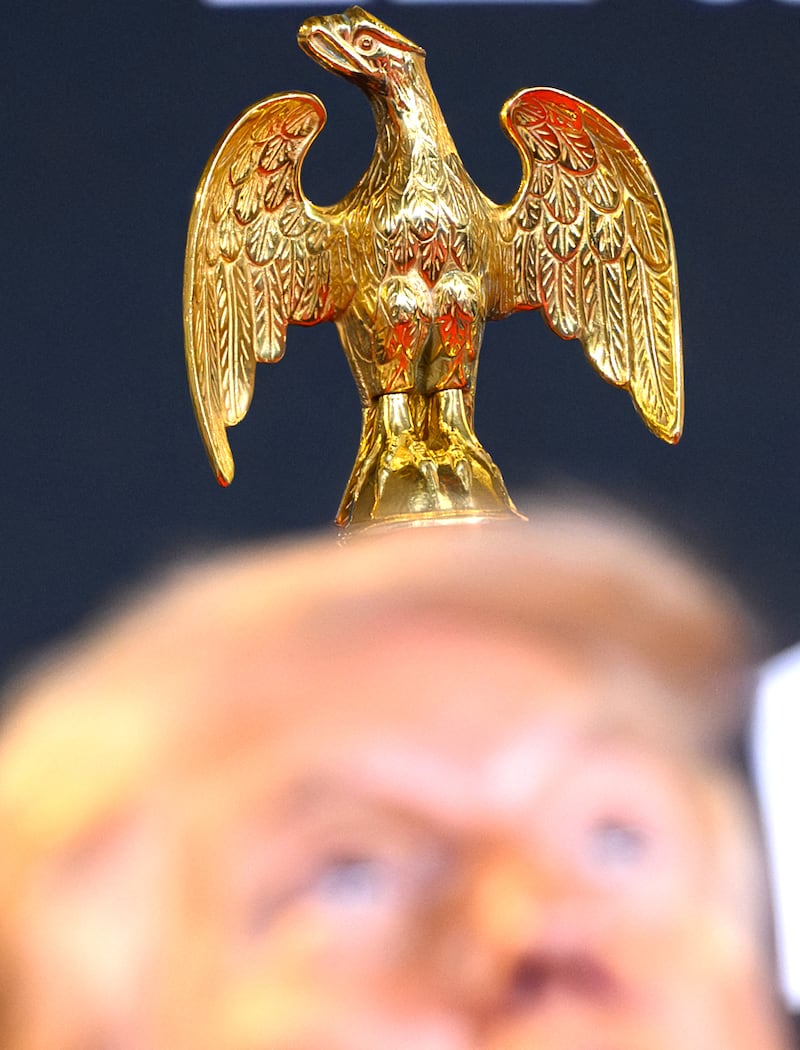 A gold finial of an eagle is seen behind US President Donald Trump