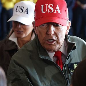 U.S. President Donald Trump and First Lady Melania Trump greet people as they arrive on the USS George H.W. Bush aircraft carrier on October 5, 2025 off the eastern coast of the United States. President Trump is visiting Naval Station Norfolk in Virginia for a celebration of the 250th birthday of the U.S. Navy. (Photo by Alex Wong/Getty Images)