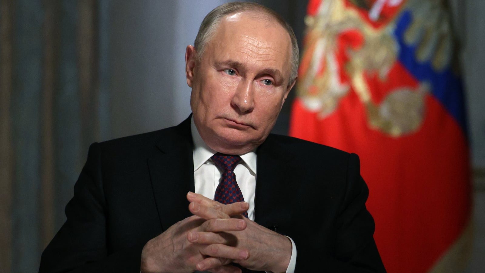 In this pool photograph distributed by Russia's state agency Sputnik, Russian President Vladimir Putin gives an interview to TV host and Director General of Rossiya Segodnya (RIA Novosti) news agency Dmitry Kiselyov (not pictured) at the Kremlin in Moscow on March 12, 2024.