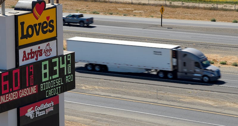 A semi drives past a sign advertising gas and diesel prices along Interstate 5 in Williams, California, U.S., September 28, 2026.
