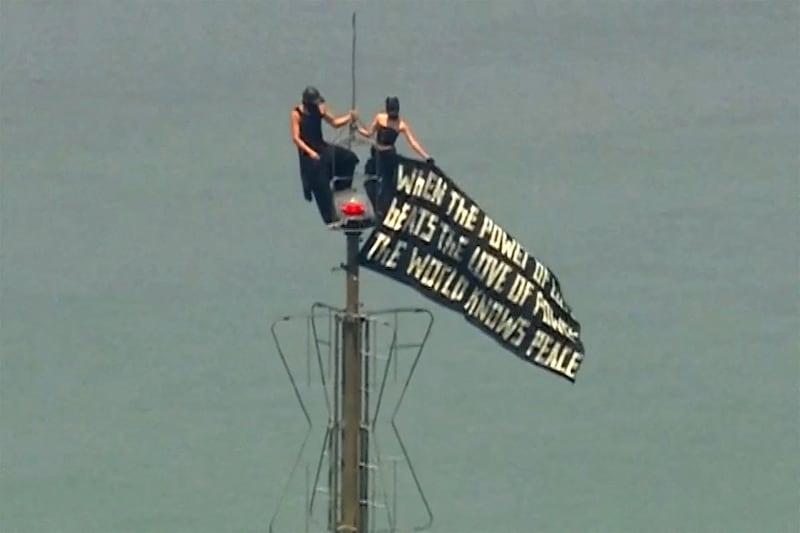 Two people display a banner atop the Empire State Building in the Manhattan borough of New York, U.S., July 1, 2026, in a still image from video.  ABC Affiliate WABC via REUTERS.  NO RESALES. NO ARCHIVES. THIS IMAGE HAS BEEN SUPPLIED BY A THIRD PARTY