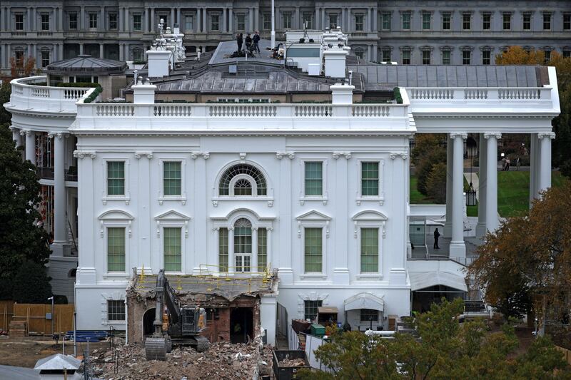 An excavator sits on the rubble after the East Wing of the White House was demolished