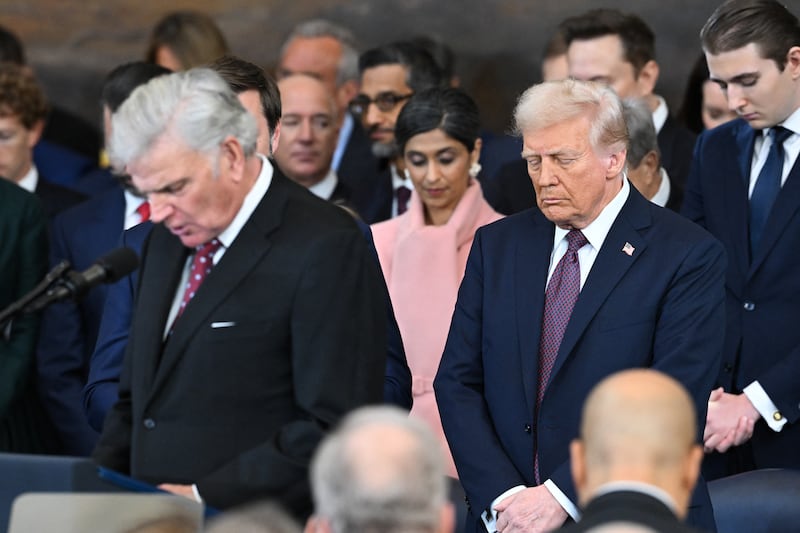 US President-elect Donald Trump (C) bows his head as US evangelist president of Samaritan's Purse Franklin Graham delivers an invocation during the inauguration ceremony before Trump is sworn in as the 47th US President in the US Capitol Rotunda in Washington, DC, on January 20, 2025.