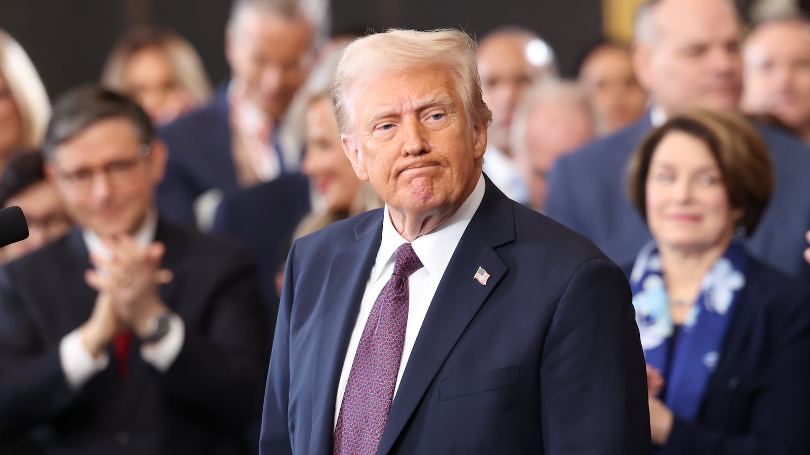 President Donald Trump stands and receives applause at his inauguration.
